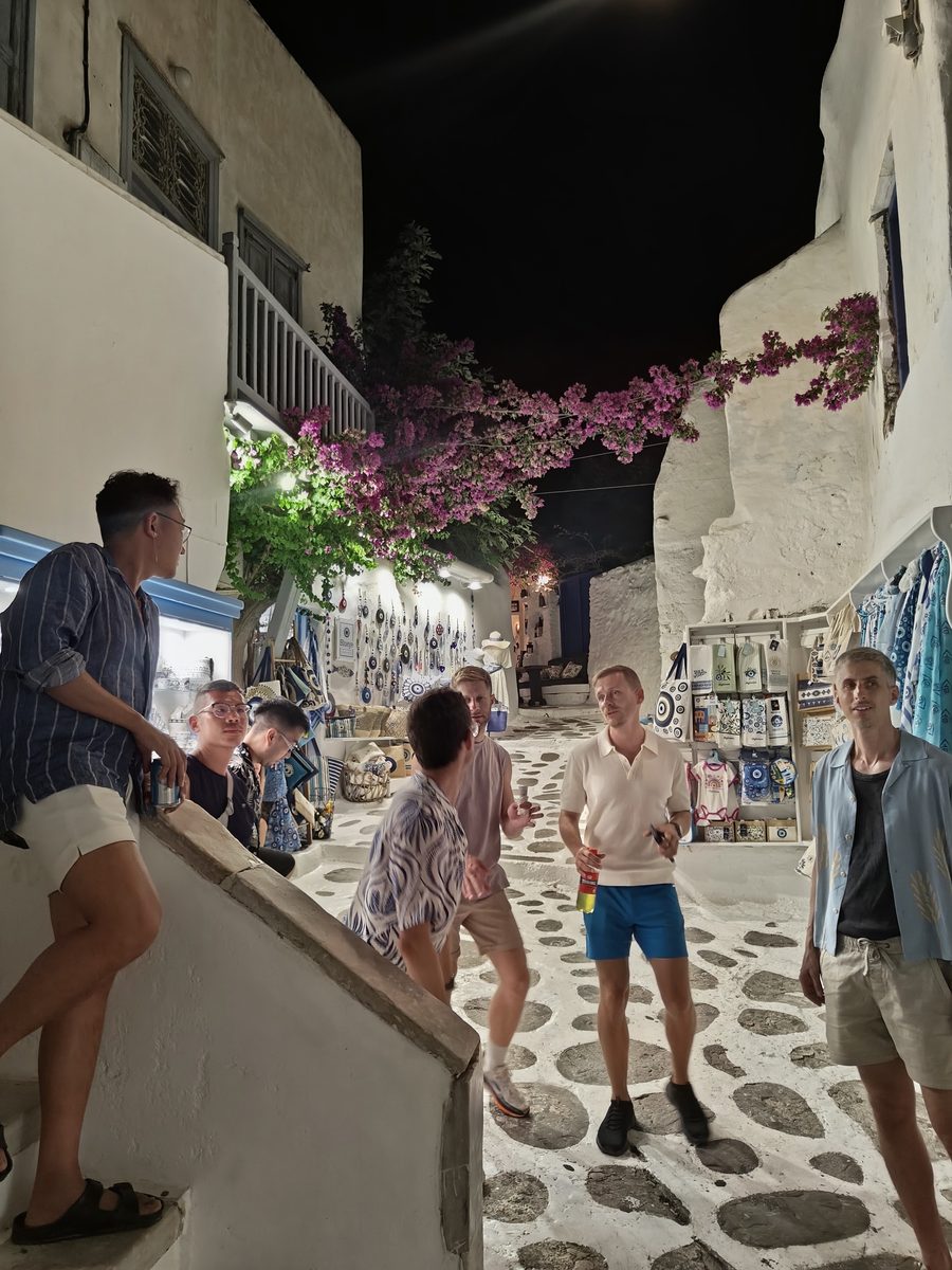 The group out in a narrow whitewashed street in the evening
