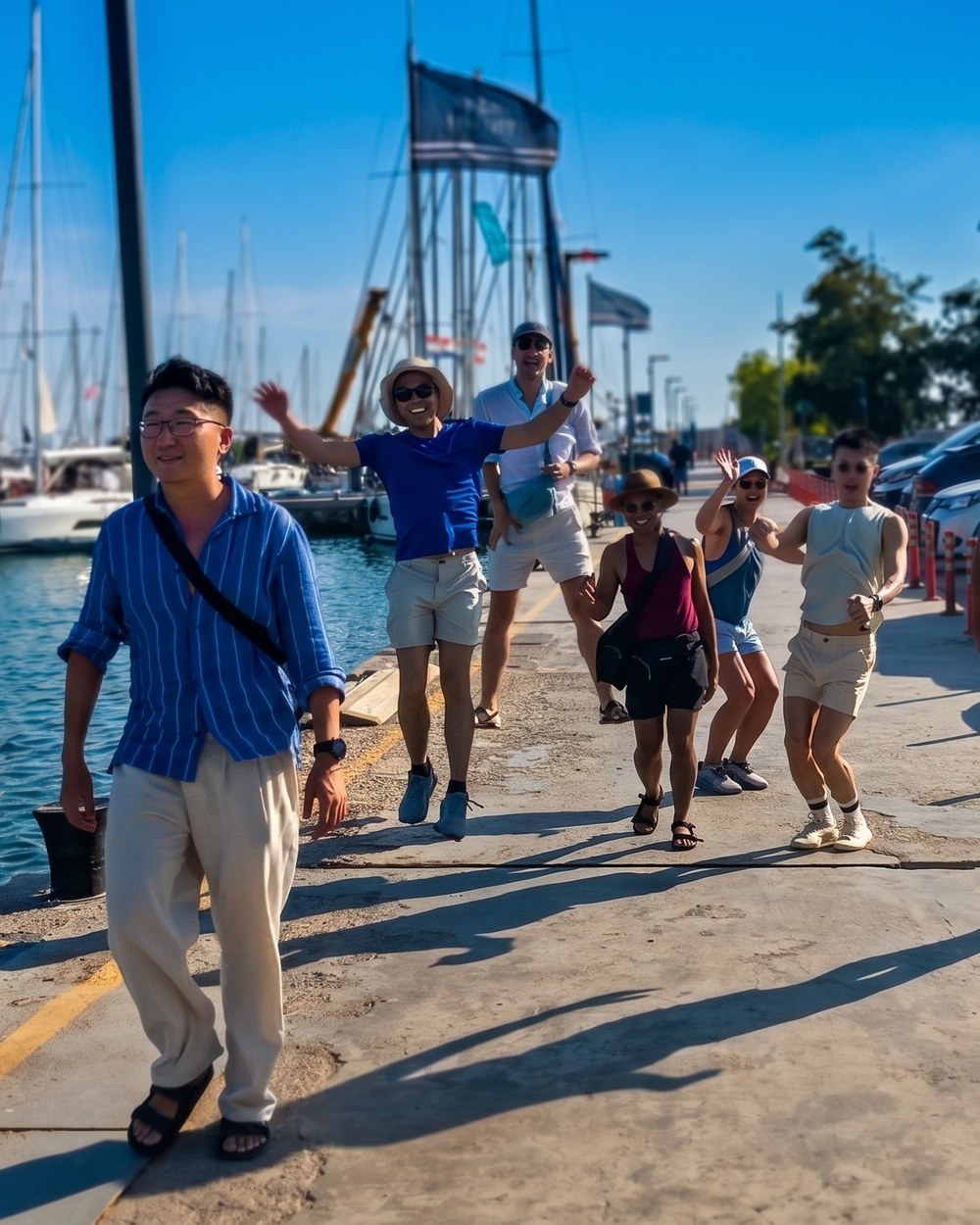 The group heading down the dock to the boat, bags in hand